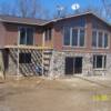 Icf walkout basement with cultered stone faced over forms