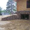 Stone front with concrete retaining wall